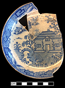 Pearlware printed underglaze blue saucer in Bungalow pattern.  Marked pieces in this pattern by Davenport (1794-1887) have been attributed as dating prior to 1810 (TCC website). Rim diameter:  5.25”. Lot 185-38. 18BC66.
